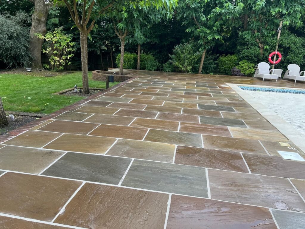 Sandstone patio alongside swimming pool