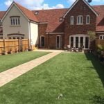 New artificial lawn and block paved path