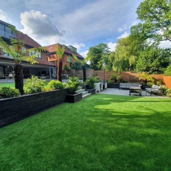 Garden project with new artificial lawn, outdoor kitchen, and flower bed creation